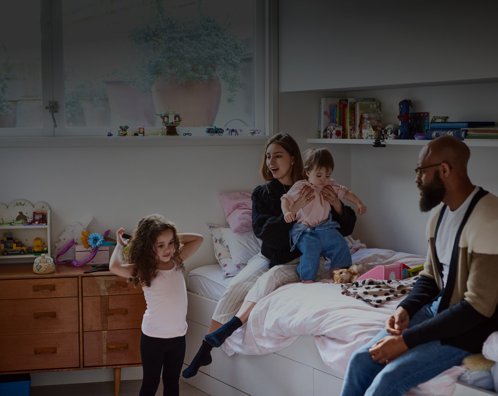 Parents sitting on the floor playing with their child