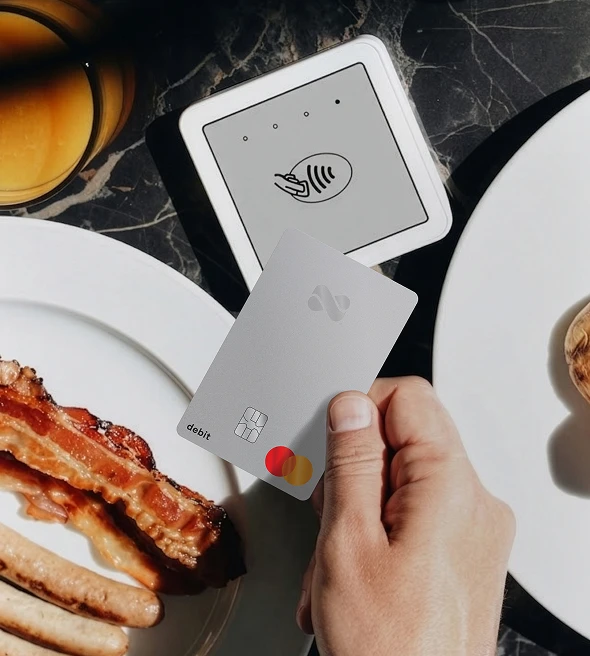 Tapping to pay for a brunch meal with a Netspend Debit Mastercard