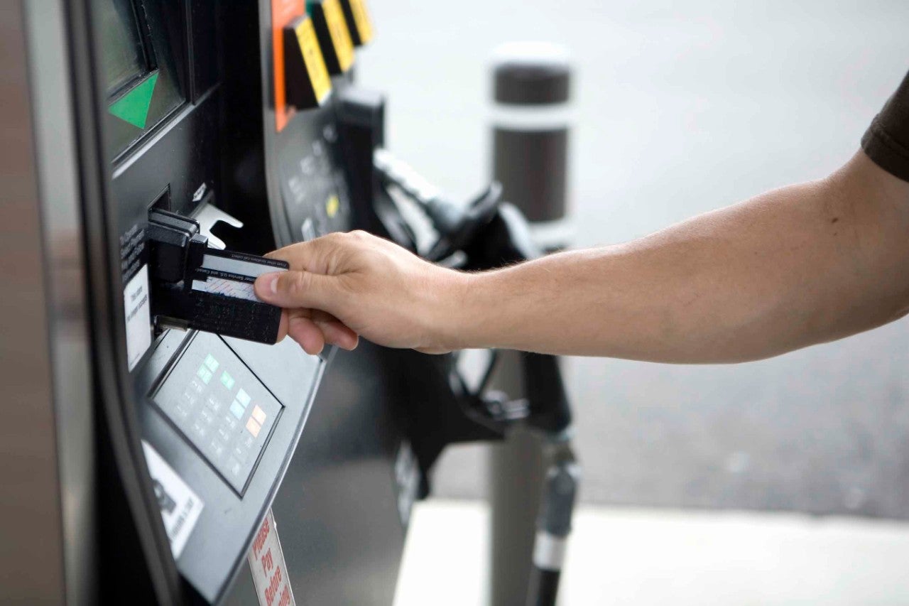Person waiting for card authorization at gas pump 