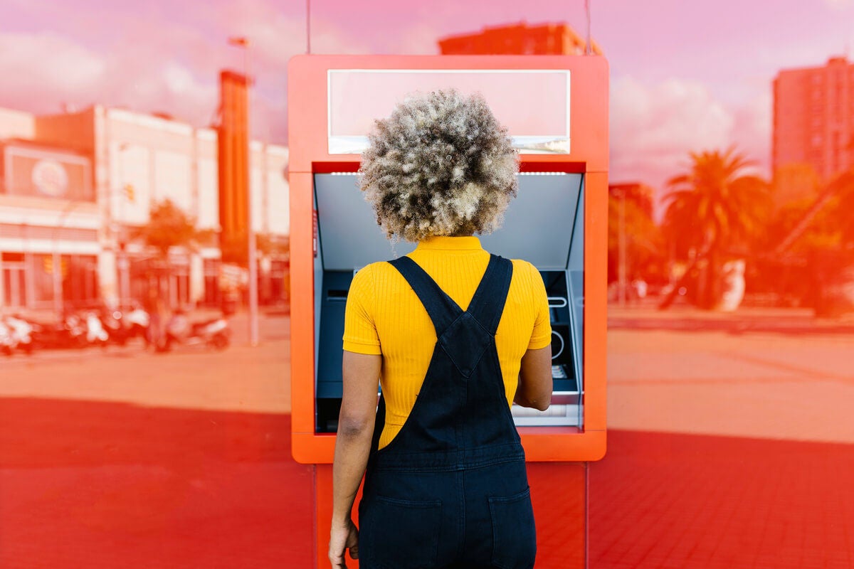 Woman getting a cash advance at an ATM